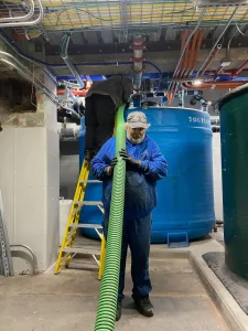 A Madden employee holding a piece of flexible piping