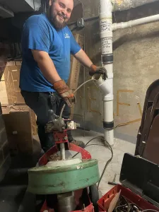 A Madden employee clearing a pipe